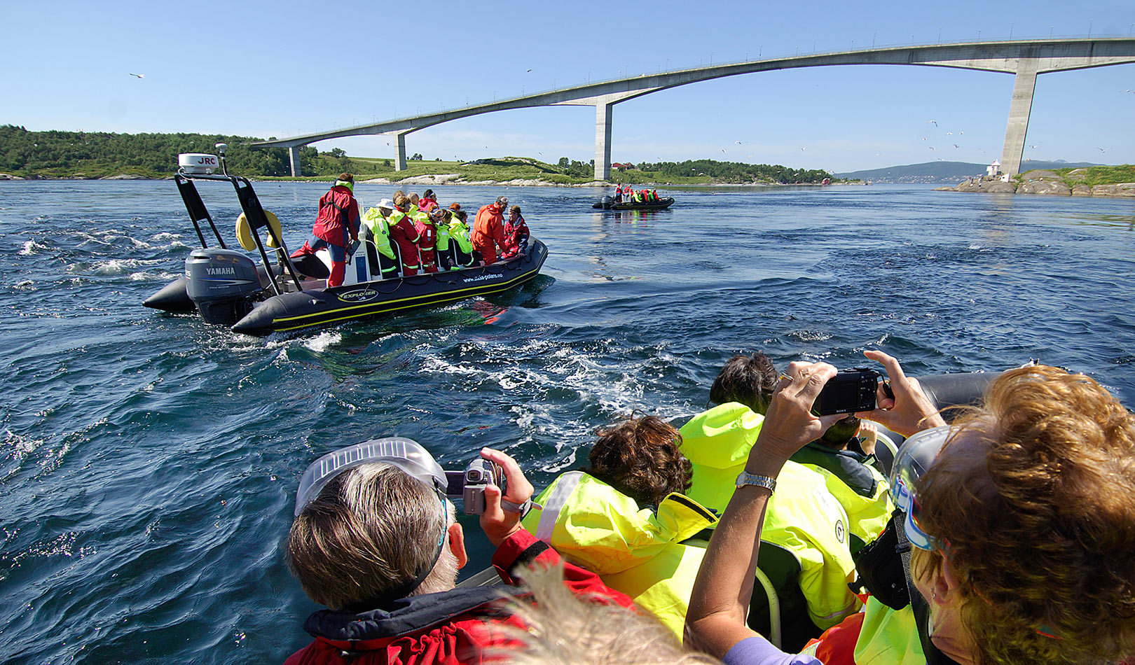 People on a RIB tour by the bridge of the maelstrom Saltstraumen outside Bodø.